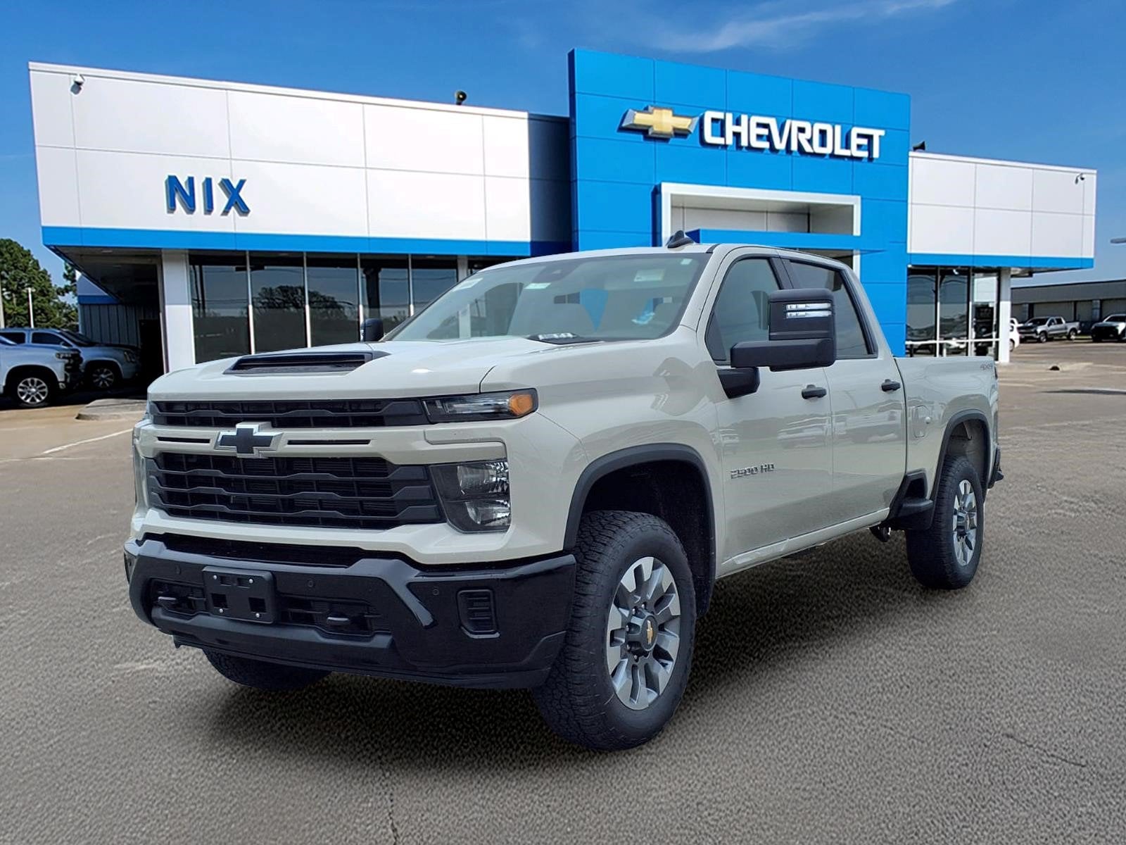 2026 Chevrolet Silverado 2500 HD Custom in White Sands — front three-quarter view