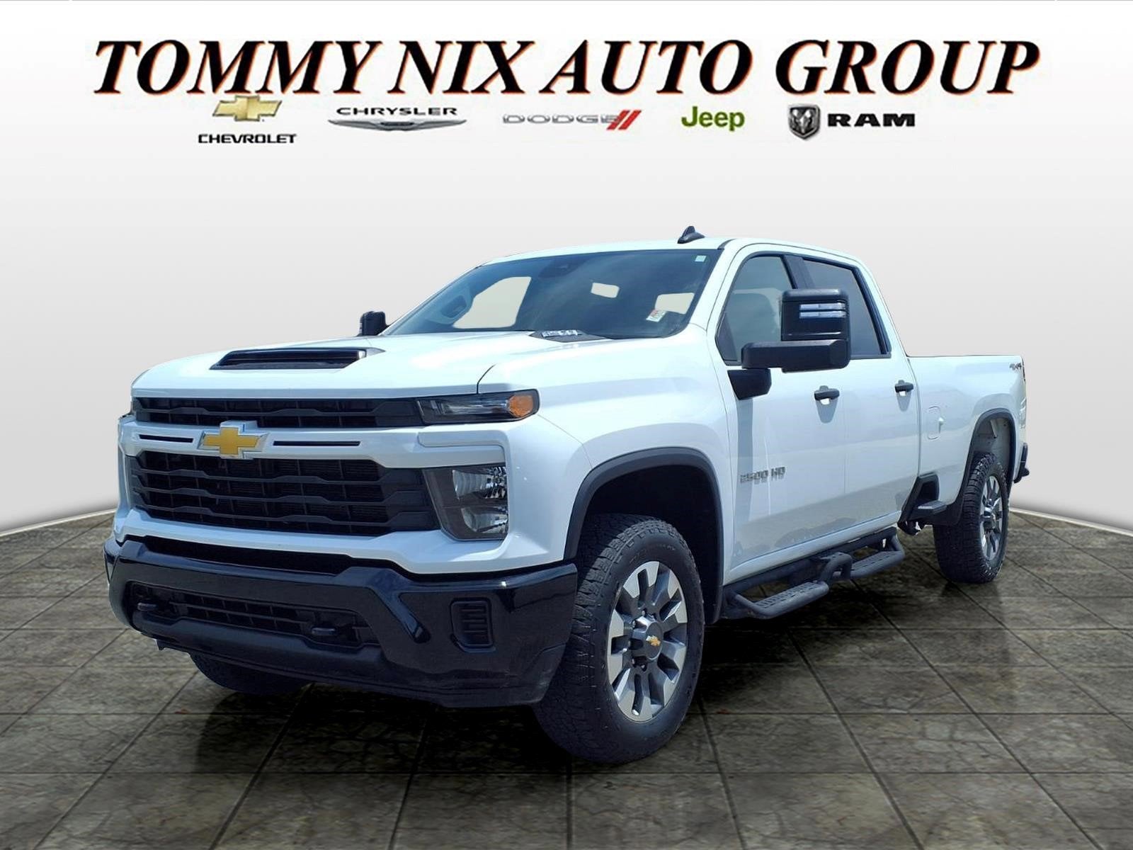2024 Chevrolet Silverado 2500 HD Custom in Summit White — front three-quarter view